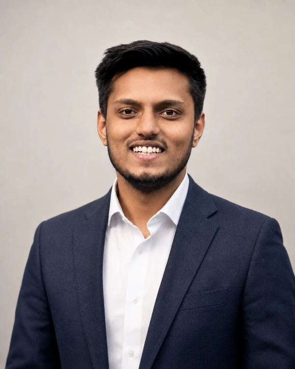 Dhiraj Kumar Chaudhary, smiling in a navy jacket.